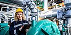 Portrait,Of,Female,Industrial,Or,Refinery,Worker,Standing,By,Generators